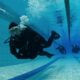 person learning to scuba dive in a swimming pool which is one of the things you can do in the Kawartha Lakes to escape winter