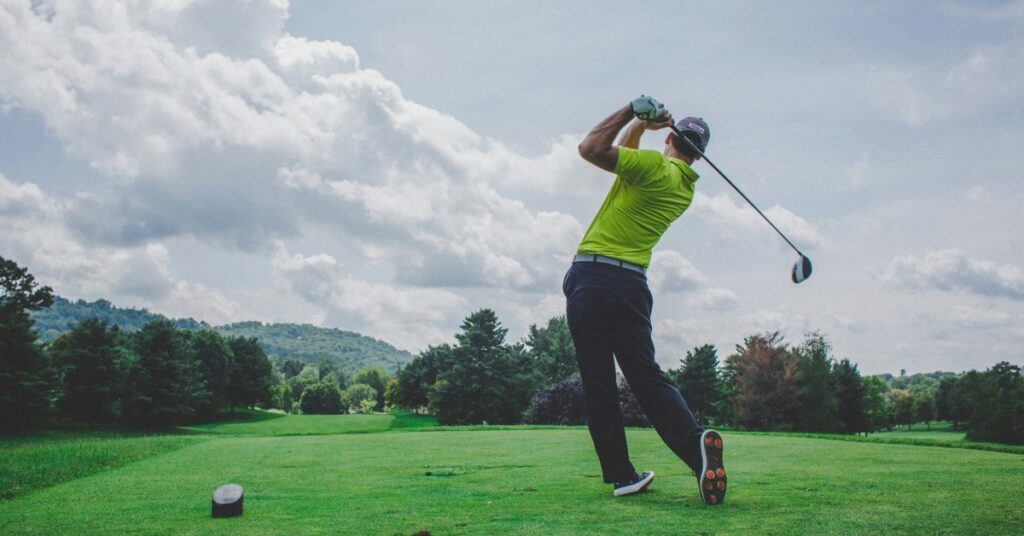 male golfer teeing off at one of the golf courses in the Kawartha Lakes region