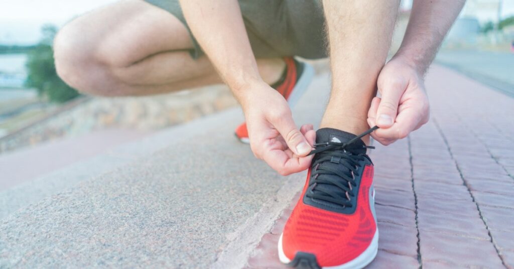 runner lacing up their shoe in preparation for the Fenelon Falls Turkey Trot race in Kawartha Lakes